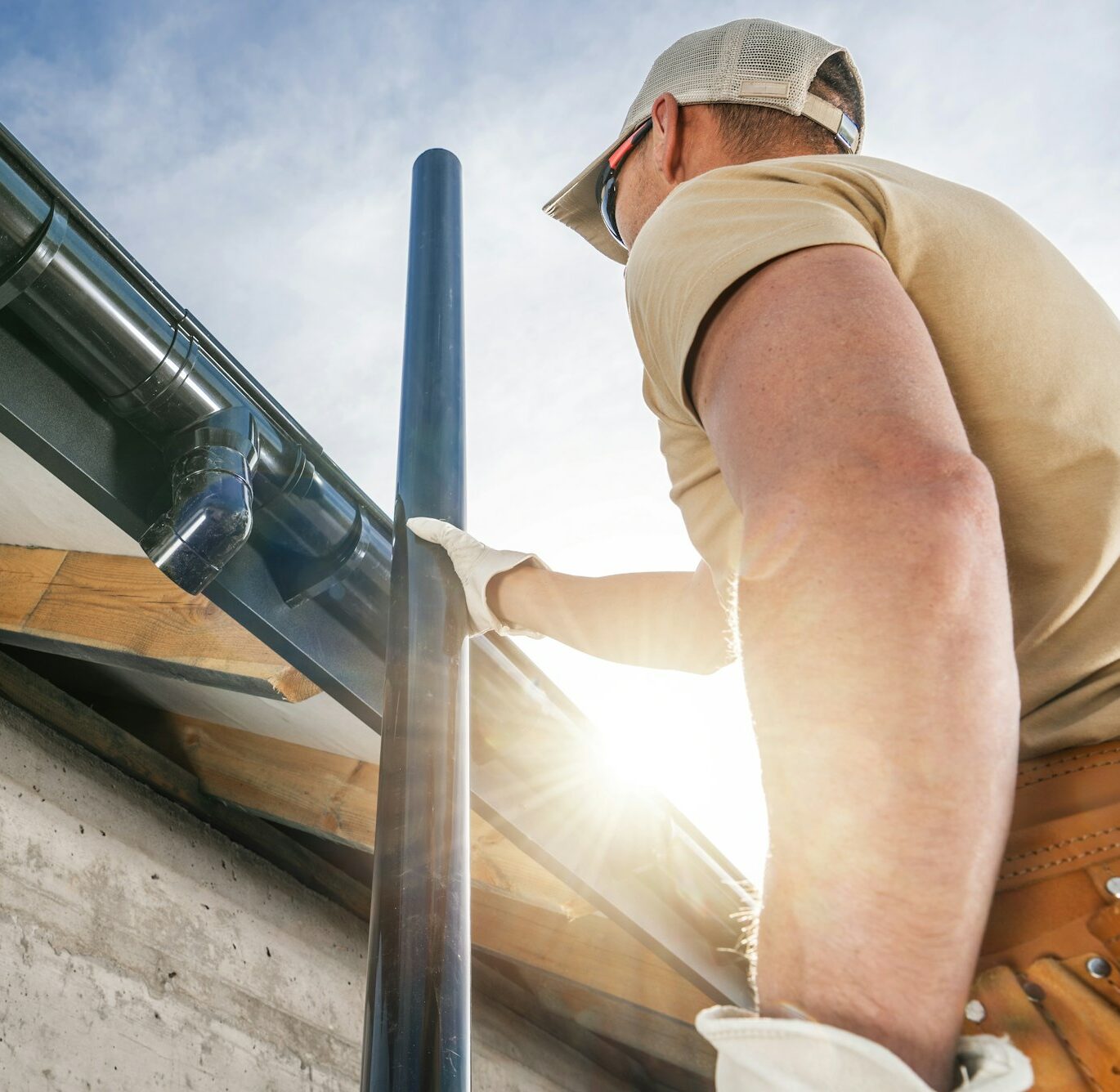 Construction Roof Worker Installing House Gutters